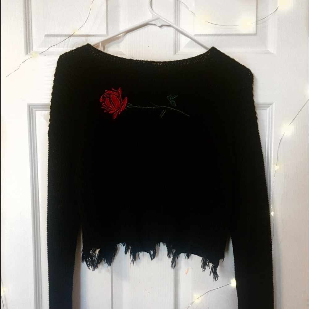 Rose embroidered distressed sweater.